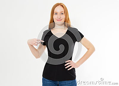 T-shirt design, happy people concept - smiling red hair woman in blank black t-shirt pointing her fingers at herself, red head Stock Photo