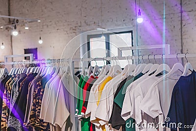 T shirt many color on rack. T shirt store in shopping mall, clothing shop. Men wear. Stock Photo