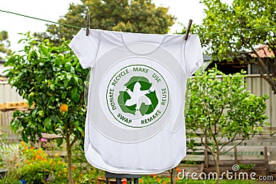 T shirt on washing line with circular economy textiles icon, make, use, reuse, swap, donate, recycle with eco clothes recycle icon Stock Photo