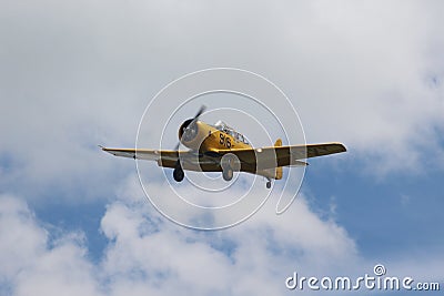 T-6 Texan Airplane Flying through the Clouds Editorial Stock Photo