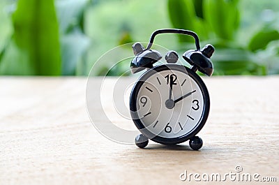 Table alarm clock pointing at 2pm or 2am with customizable space for text. Time management concept and copy space Stock Photo