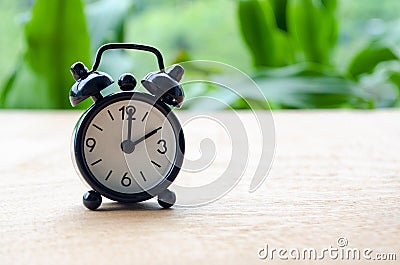 Table alarm clock pointing at 2pm or 2am with customizable space for text. Time management concept and copy space Stock Photo