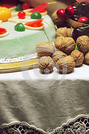 Table arrangement walnuts cherry cake Stock Photo