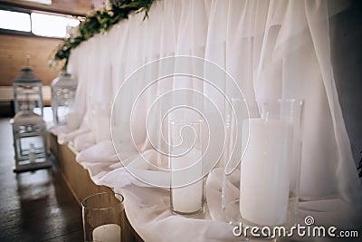 The table of the bride and groom is decorated with candles and candlesticks Stock Photo