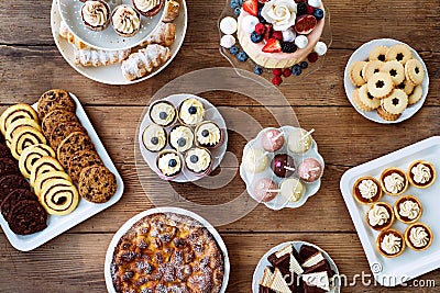 Table with cake, pie, cupcakes, cookies, tarts and cakepops Stock Photo