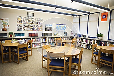 Table And Chairs Arranged In High School Library Stock Photo