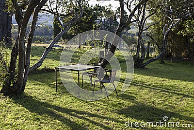 Table and chairs in a country house garden. Bingie. Australia. Stock Photo