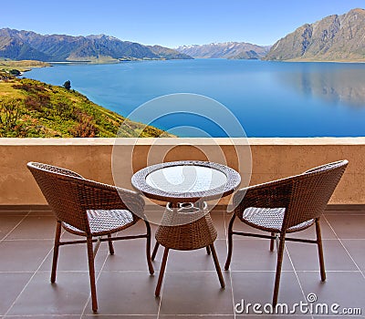 Table and chairs on a terrace, view on a lake Stock Photo