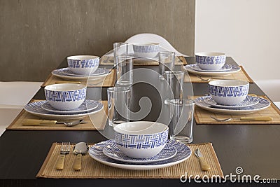 A table with crockery, plates, glasses and cutlery Stock Photo