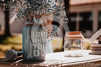 Table decorated for a wedding with flowers and a vase with a motivating phrase Stock Photo