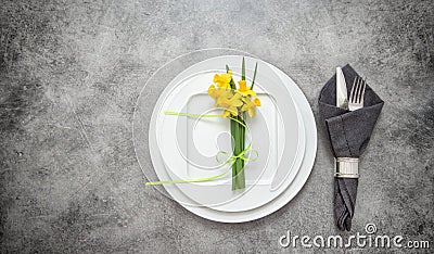 Table decoration cutlery, napkin, narcissus flowers Stock Photo