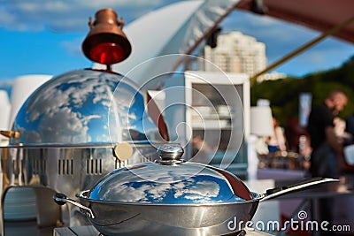 Table with dishware and marmites waiting for guests. Stock Photo