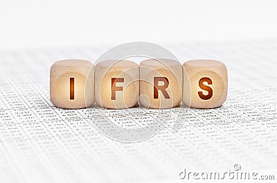 On the table with documents are wooden cubes with the inscription - IFRS Stock Photo