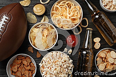 Tasty snacks and beer prepared for watching American football on table Stock Photo