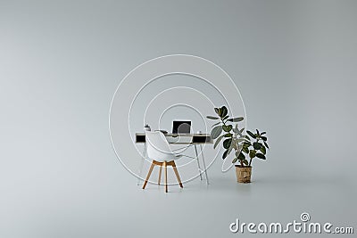 Table with laptop, white chair and Stock Photo
