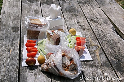 On the table lie painted eggs, sliced cucumbers and tomatoes Stock Photo