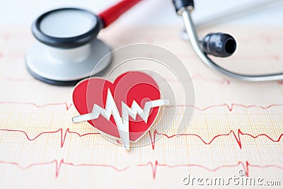 On table lies stethoscope cardiogram and heart sign Stock Photo
