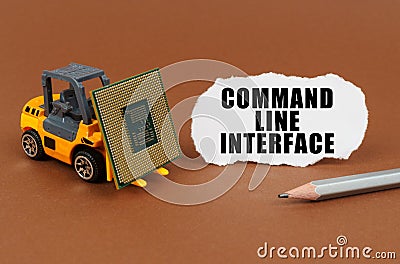 On the table, the loader transports the processor, next to it is paper with the inscription - Command Line Interface Stock Photo