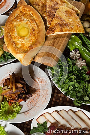 Table with normal food, steaks and potatoes. Stock Photo