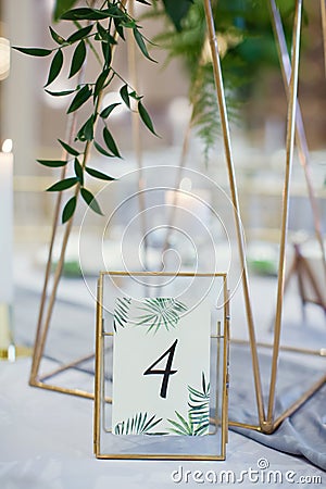 Table number and exotic palm leaves Stock Photo