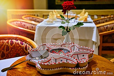 Table with a plate in the Arab style and a flower. Arab cafe in Tunisia, middle East Stock Photo