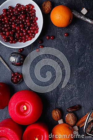 On a table a plate twith cranberry, oranges and burning candles. View from above. Indoors. Stock Photo