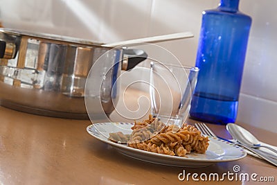 Table ready to eat, pasta dish and pot, humble meal Stock Photo