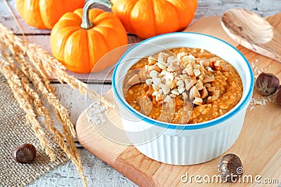 Table scene with bowl of autumn pumpkin oatmeal Stock Photo