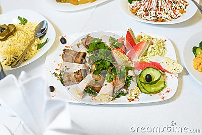 Table served with delicious food. cooked salad, meat, stuffed crab sticks Stock Photo