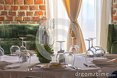 Table set with candles in a luxurious restaurant with brick wall Stock Photo
