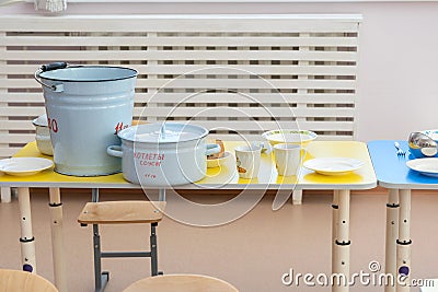 Table setting before meals in kindergarten. The inscription on the pan in Russian Stock Photo