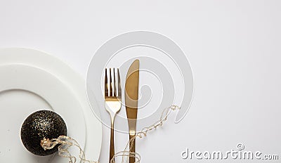 Table setting, xmas, new year. Gold cutlery on white set of dishes, white background Stock Photo