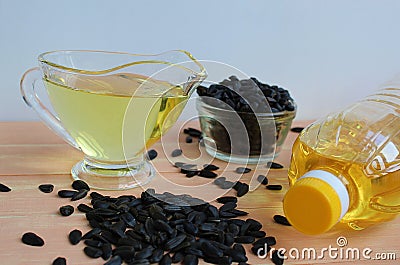 On the table is sunflower oil and sunflower seeds Stock Photo