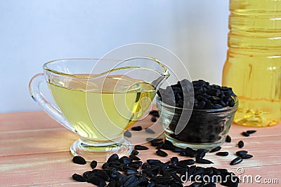 On the table is sunflower oil and sunflower seeds Stock Photo