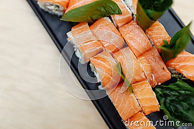 On table sushi roll food fish philadelphia japanese salmon delicious sushi rice cucumber meal traditional wasabi fresh healthy Stock Photo