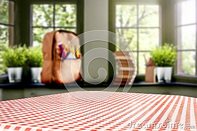 Table top space for your products and a schoolbag in the kitchen background. Some school accessories on windowsill. Stock Photo