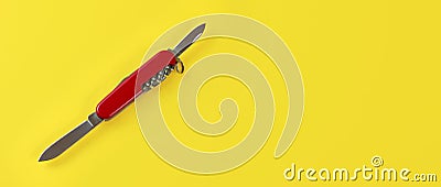 Table top view, red pocket knife with both blades opened, on yellow board. Space for text on right Stock Photo