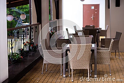 Table and wicker chairs in a brown cafe Stock Photo