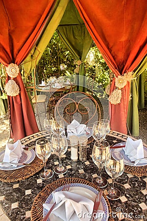 Table with wineglasses in outdoor pavilion Stock Photo