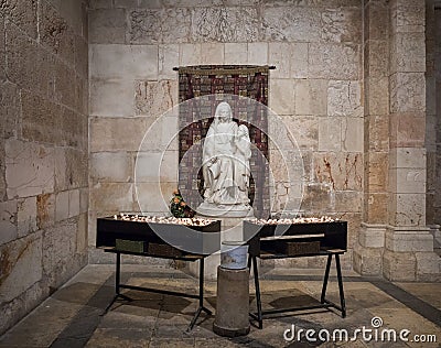 Tables with candles stand in front of the statue in the Church of Saint Anne near Pools of Bethesda in the old city of Jerusalem, Editorial Stock Photo