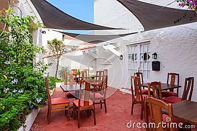 Tables with chairs in a restaurant on Menorca. Editorial Stock Photo