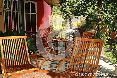 Tables and chairs in a small restaurant.outdoor cafe. sitting wooden folding armchair Stock Photo