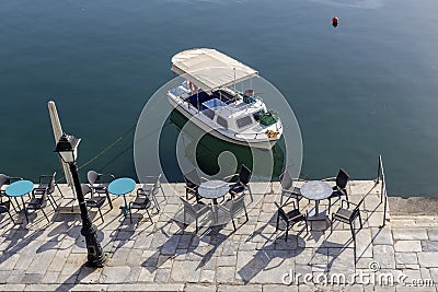 Tables and chairs of a street cafe Greece, Peloponnese Stock Photo