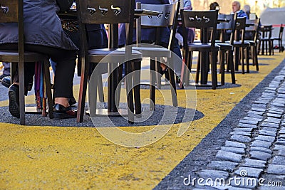 Tables and chairs in the street during the coronavirus pandemic Editorial Stock Photo