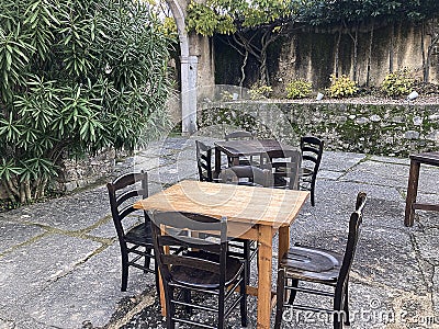 Tables with vintage chairs in a pub garden in a medieval village Stock Photo