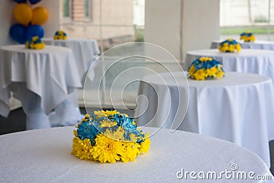 Tables with white tablecloths decorated with flowers Stock Photo