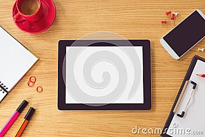 Tablet with blank white screen on wooden table. Office desk mock up. View from above Stock Photo