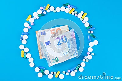 Tablet blisters and Euro banknote. Spending money on pills and expensiveness of medicine concept Stock Photo