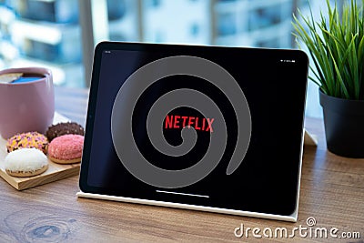 Tablet computer Apple iPad Air Space Gray with company Netflix Editorial Stock Photo