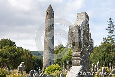 Tablet in the Glendalough Cemetery and The Round Tower Stock Photo